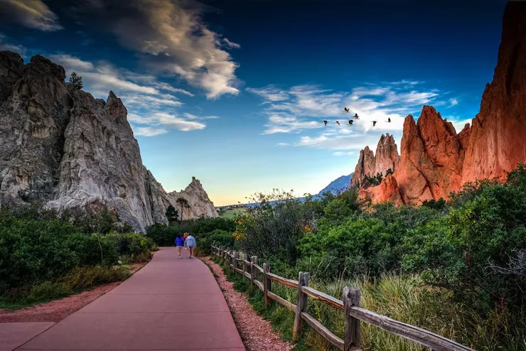imageye___-_rear-view-people-walking-footpath-by-rock-formation-plants-against-sky-colorado-springs_1048944-12789659